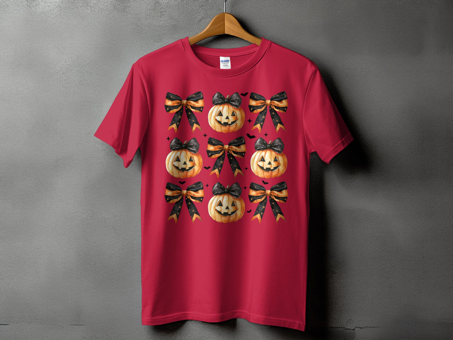 Red t-shirt with a repeating pattern of jack-o'-lanterns and black and orange bows.