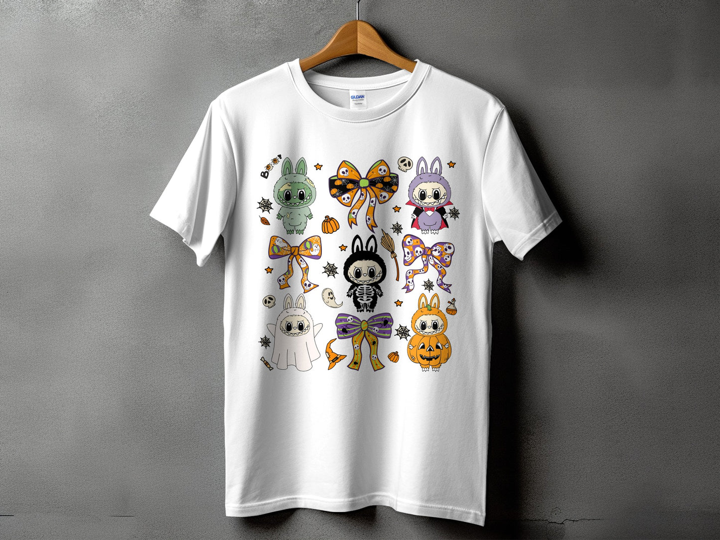 White t-shirt featuring a variety of cute Halloween-themed characters and motifs.