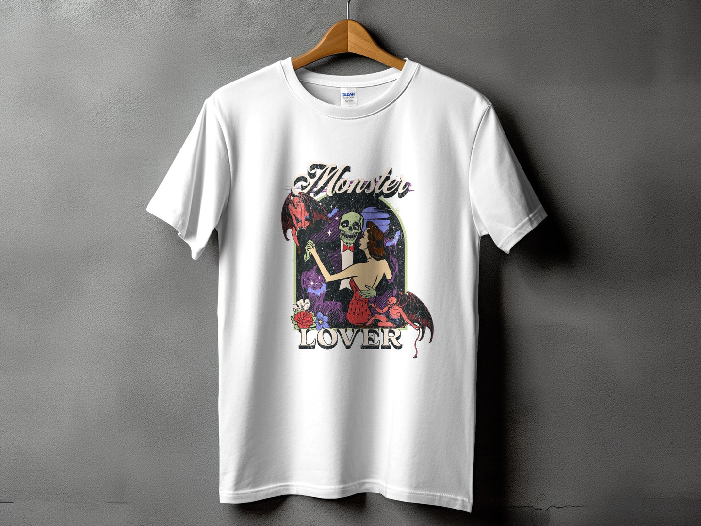 White t-shirt featuring "Monster Lover" text with skeleton and devil-like figures.