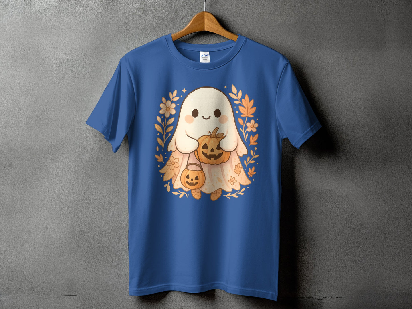 Blue t-shirt with a cute ghost holding pumpkins and surrounded by floral elements.
