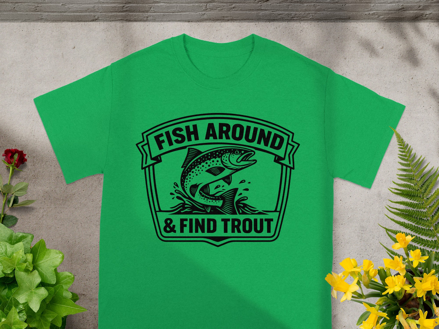 Green t-shirt with "FISH AROUND & FIND TROUT" text and trout graphic.