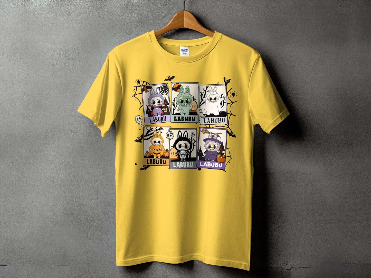 Yellow t-shirt with a six-panel Halloween-themed Labubu graphic.