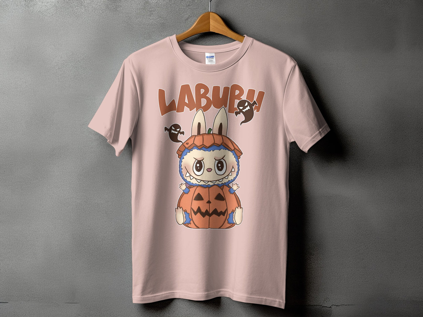 Pink t-shirt with "LABURU" text and a cartoon character in a pumpkin costume.