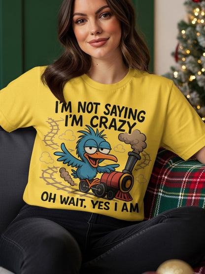Yellow t-shirt with blue bird and train graphic, text "I'M NOT SAYING I'M CRAZY OH WAIT, YES I AM".
