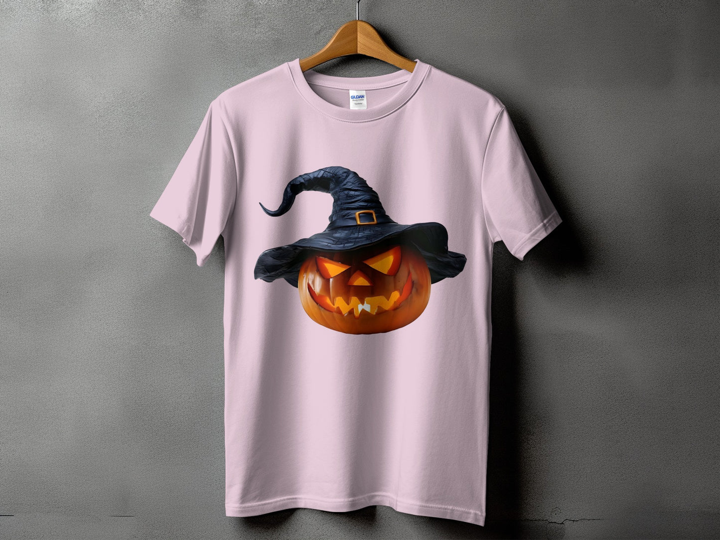 Pink t-shirt with a carved jack-o'-lantern wearing a black witch hat.