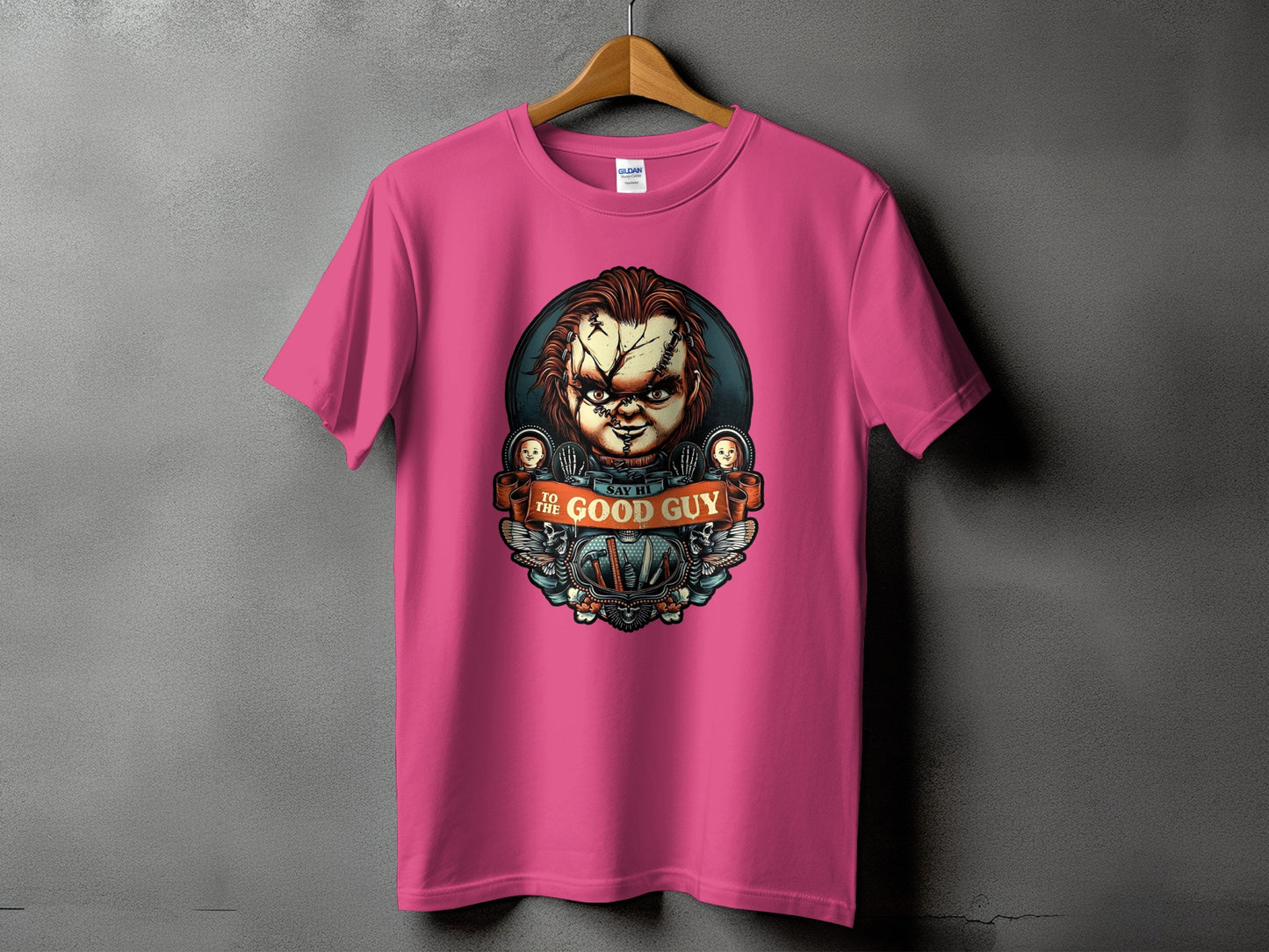 Pink t-shirt with Chucky from Child's Play graphic saying "Say Hi To The Good Guy".
