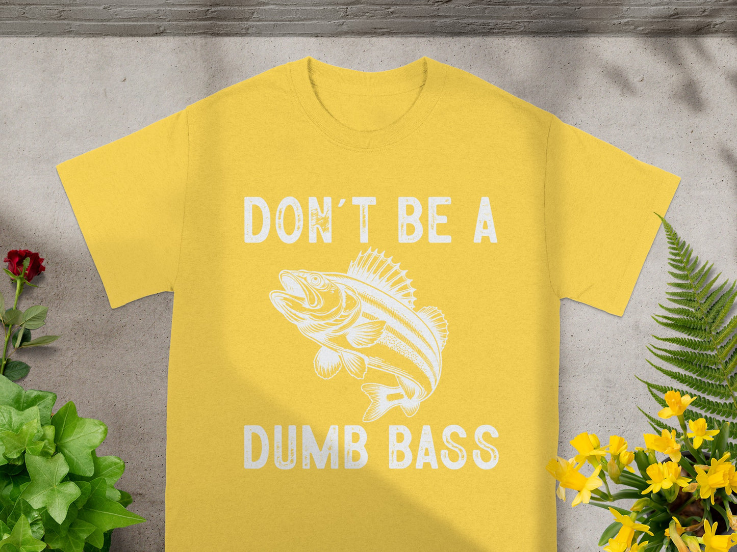 Yellow t-shirt with "DON'T BE A DUMB BASS" text and a bass fish graphic.