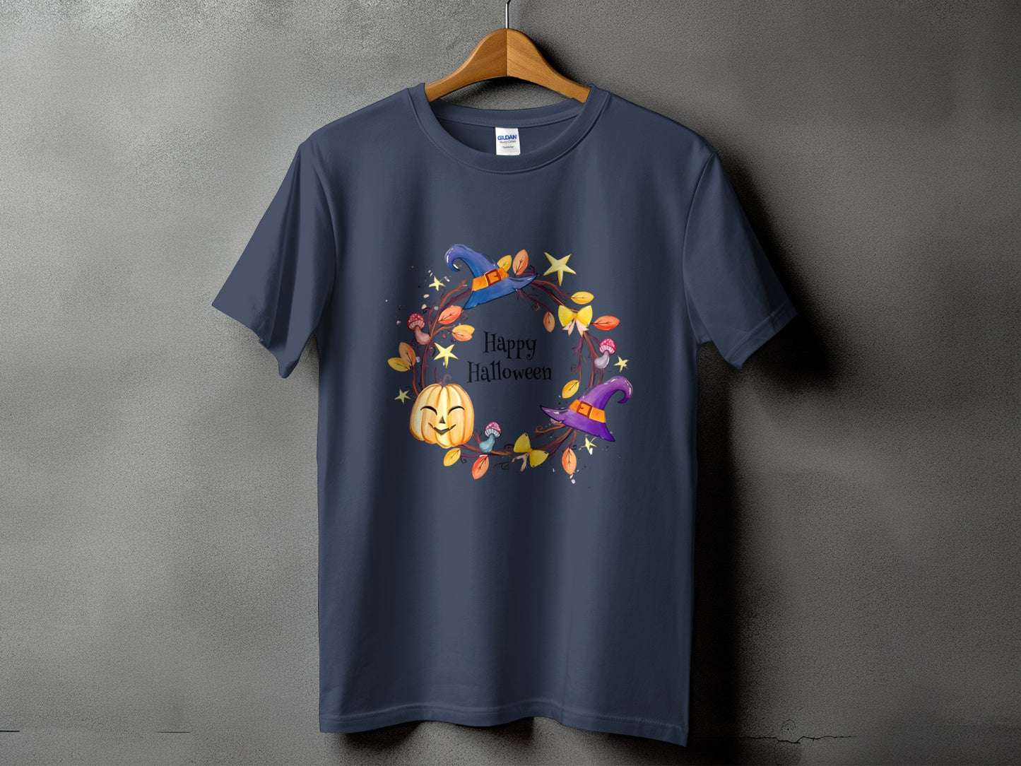 Dark blue t-shirt with a Happy Halloween wreath graphic featuring a pumpkin, witches hats, and mushrooms.