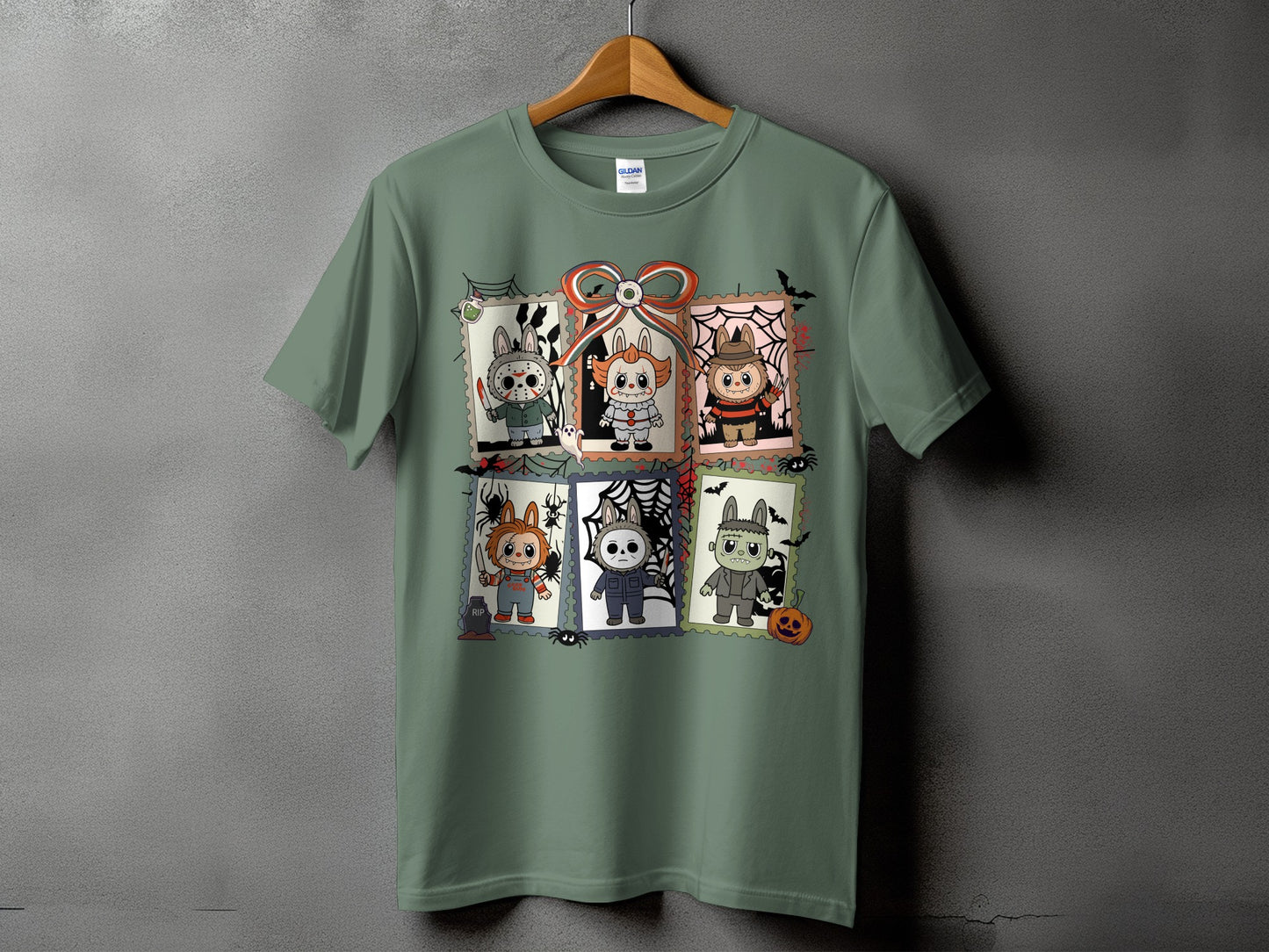 Green t-shirt featuring six postage stamps with cartoon horror characters.