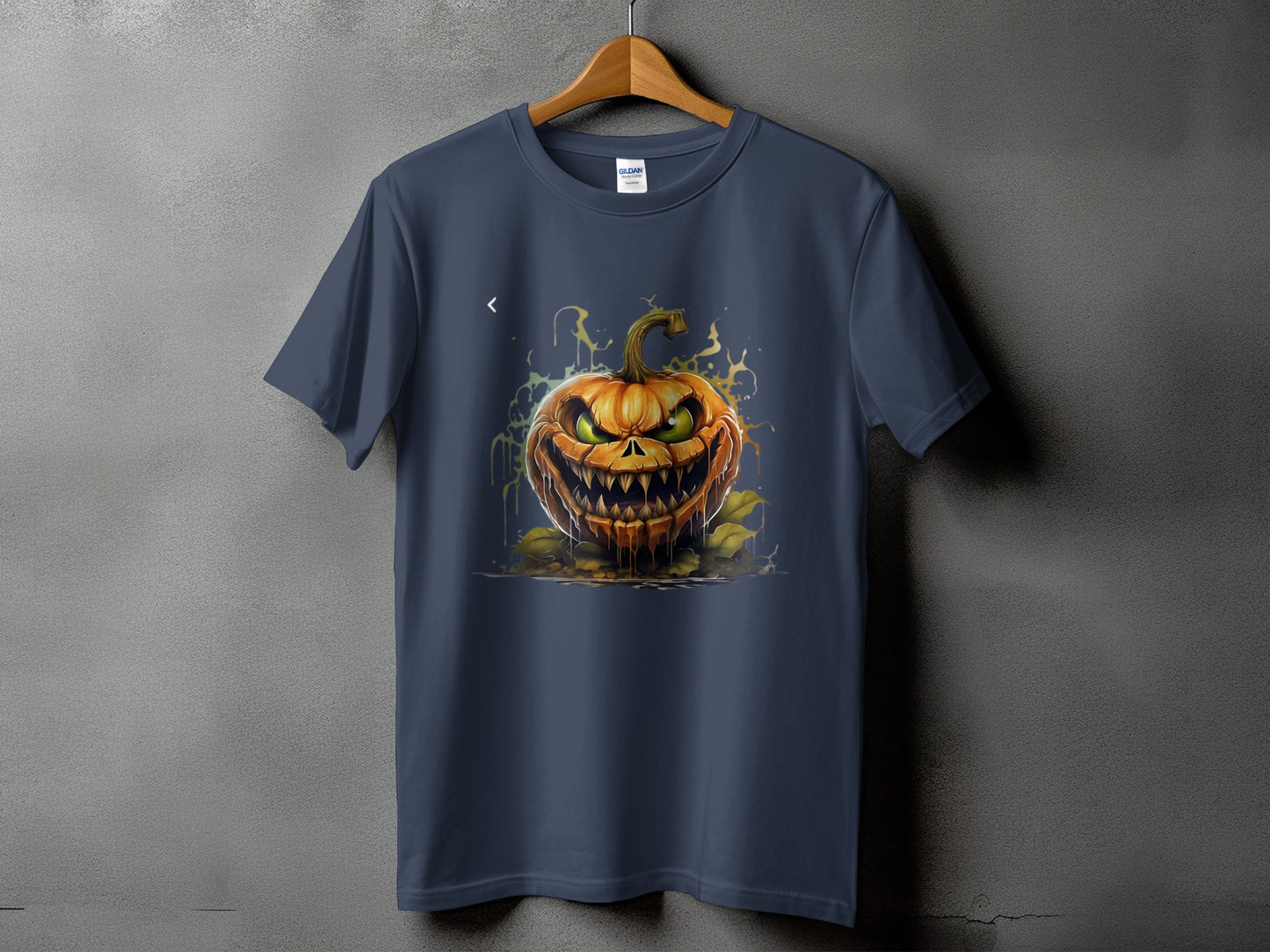 Navy t-shirt with a graphic of a spooky, dripping jack-o'-lantern with green eyes.