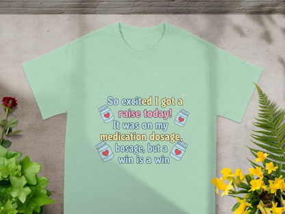 Light blue t-shirt with text "So excited I got a raise today!"
