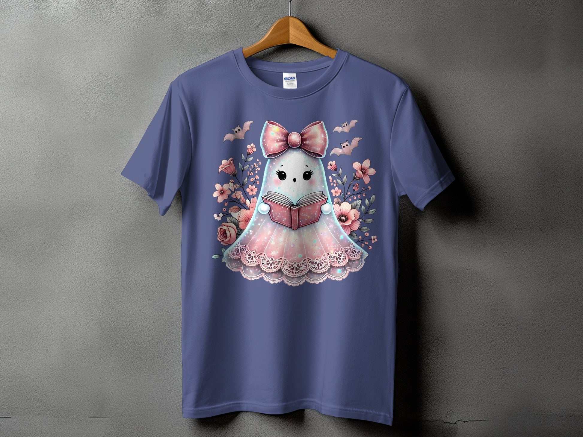 T-shirt with a cute ghost reading a book surrounded by flowers and bats.