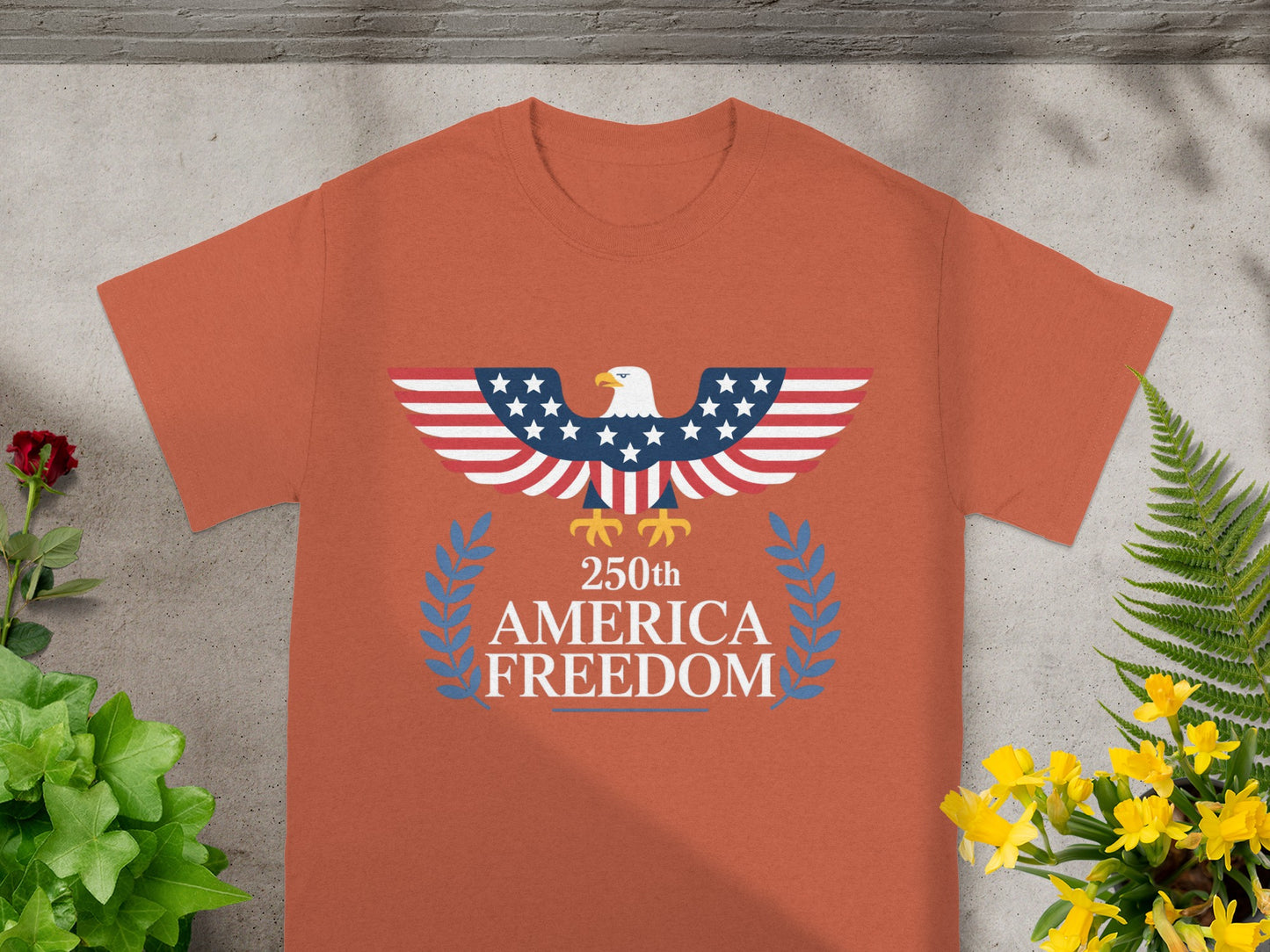 Orange t-shirt with American flag eagle and "250th America Freedom" text.