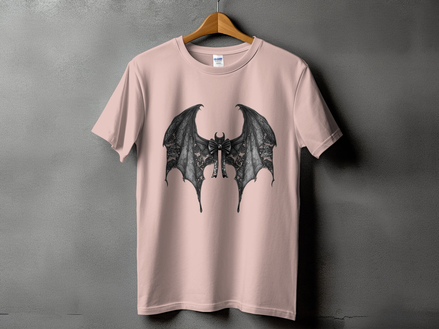 Pink t-shirt with black lace bat wings and bow graphic.