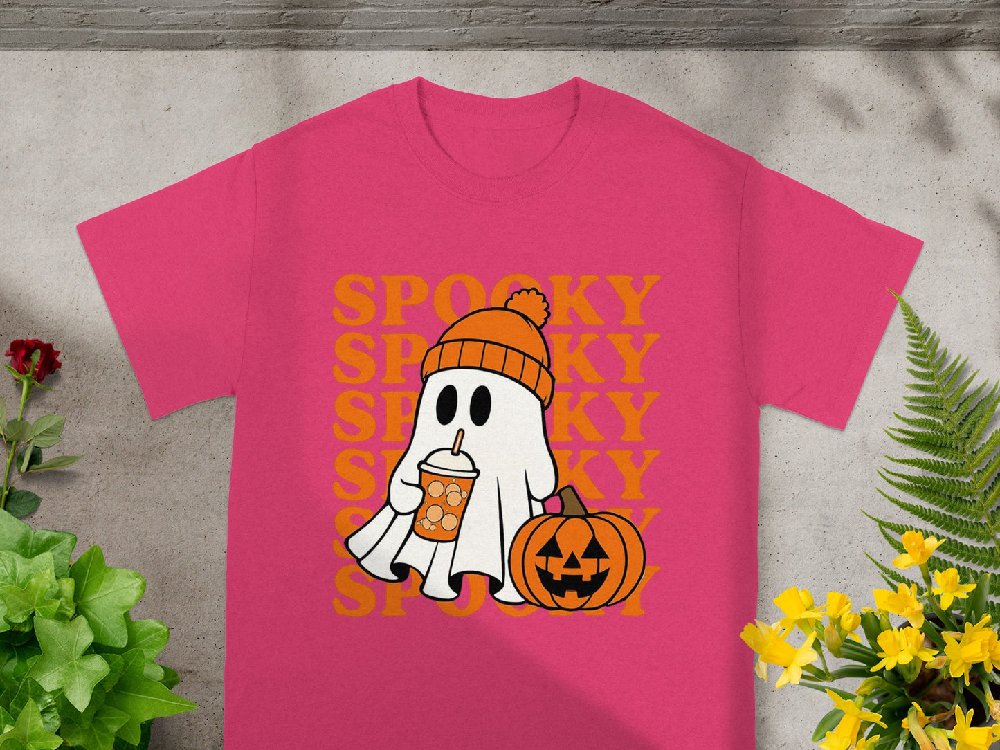 Pink t-shirt with a ghost, pumpkin, and "Spooky" text graphic.