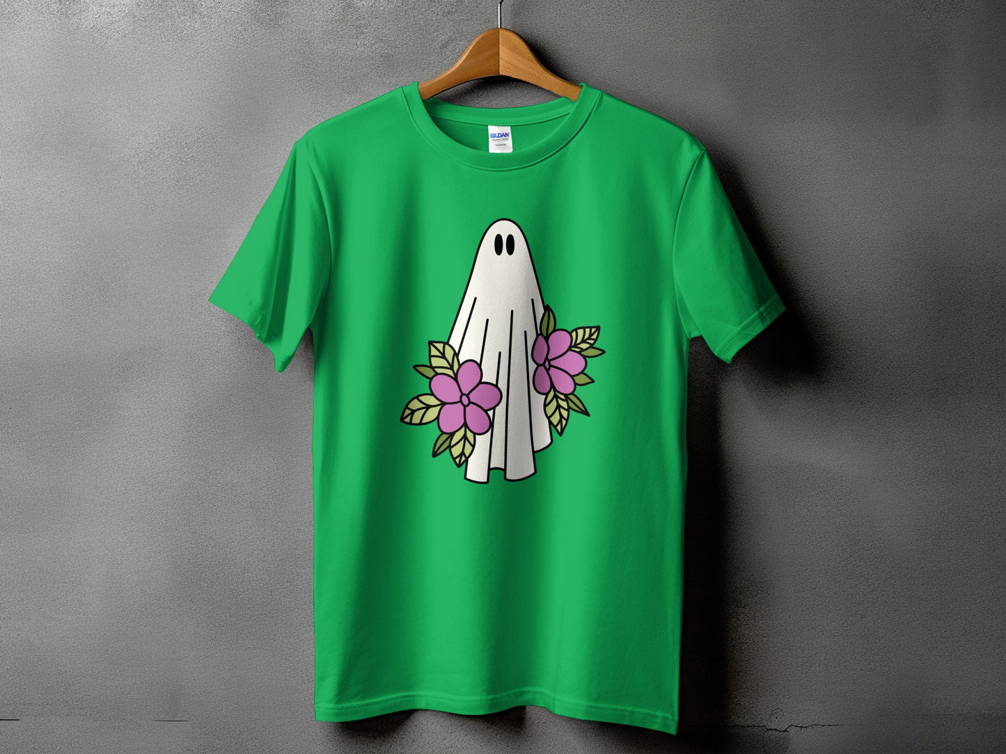 Green t-shirt with a white ghost graphic and pink flowers.