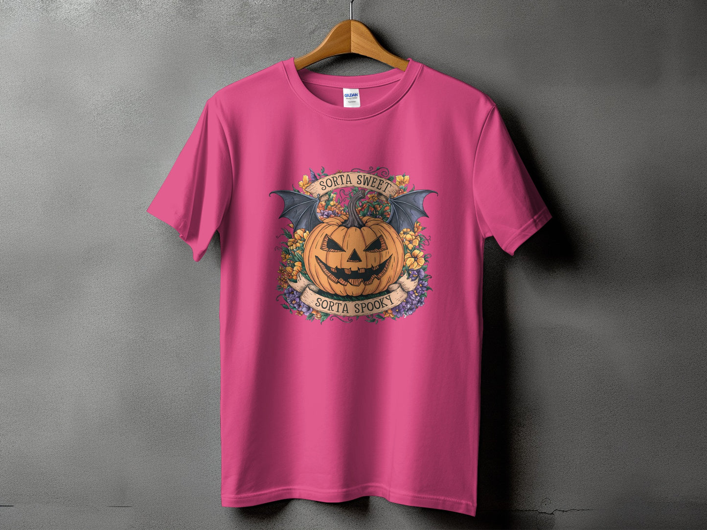Pink t-shirt with Halloween graphic of a jack-o'-lantern, bats, and text "Sorta Sweet Sorta Spooky".