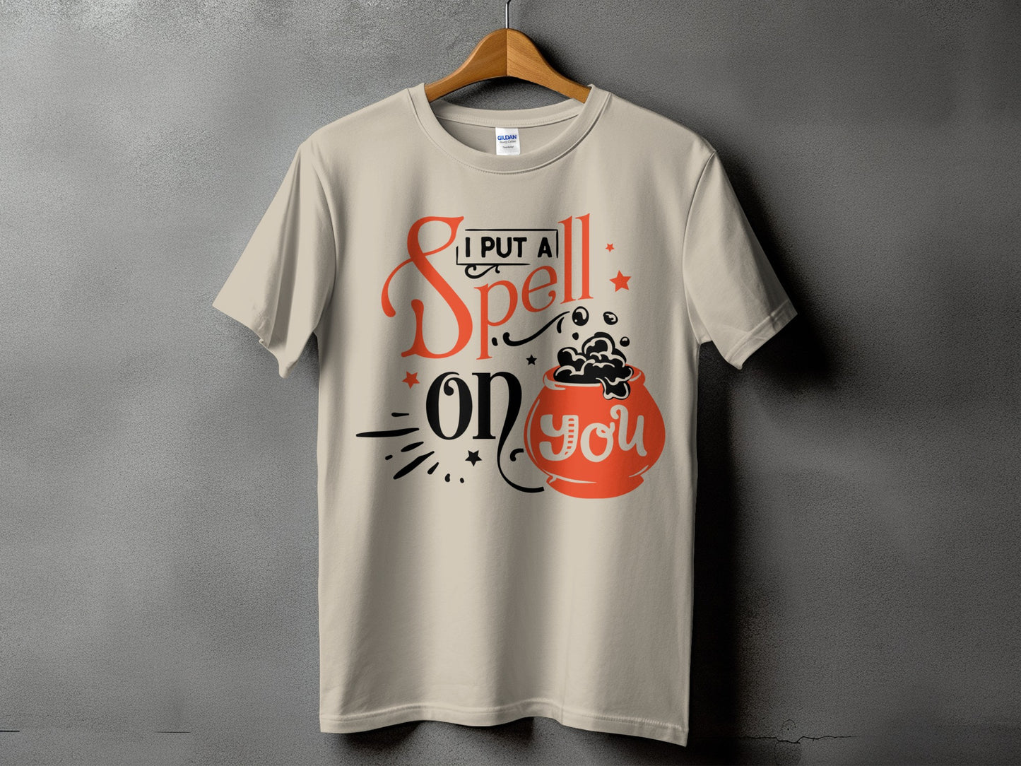 Light tan t-shirt with "I put a spell on you" text and cauldron graphic.