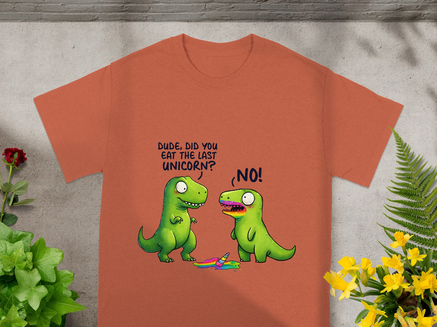 Orange t-shirt with cartoon dinosaurs and a melted unicorn. Text reads: "DUDE, DID YOU EAT THE LAST UNICORN?" "NO!"