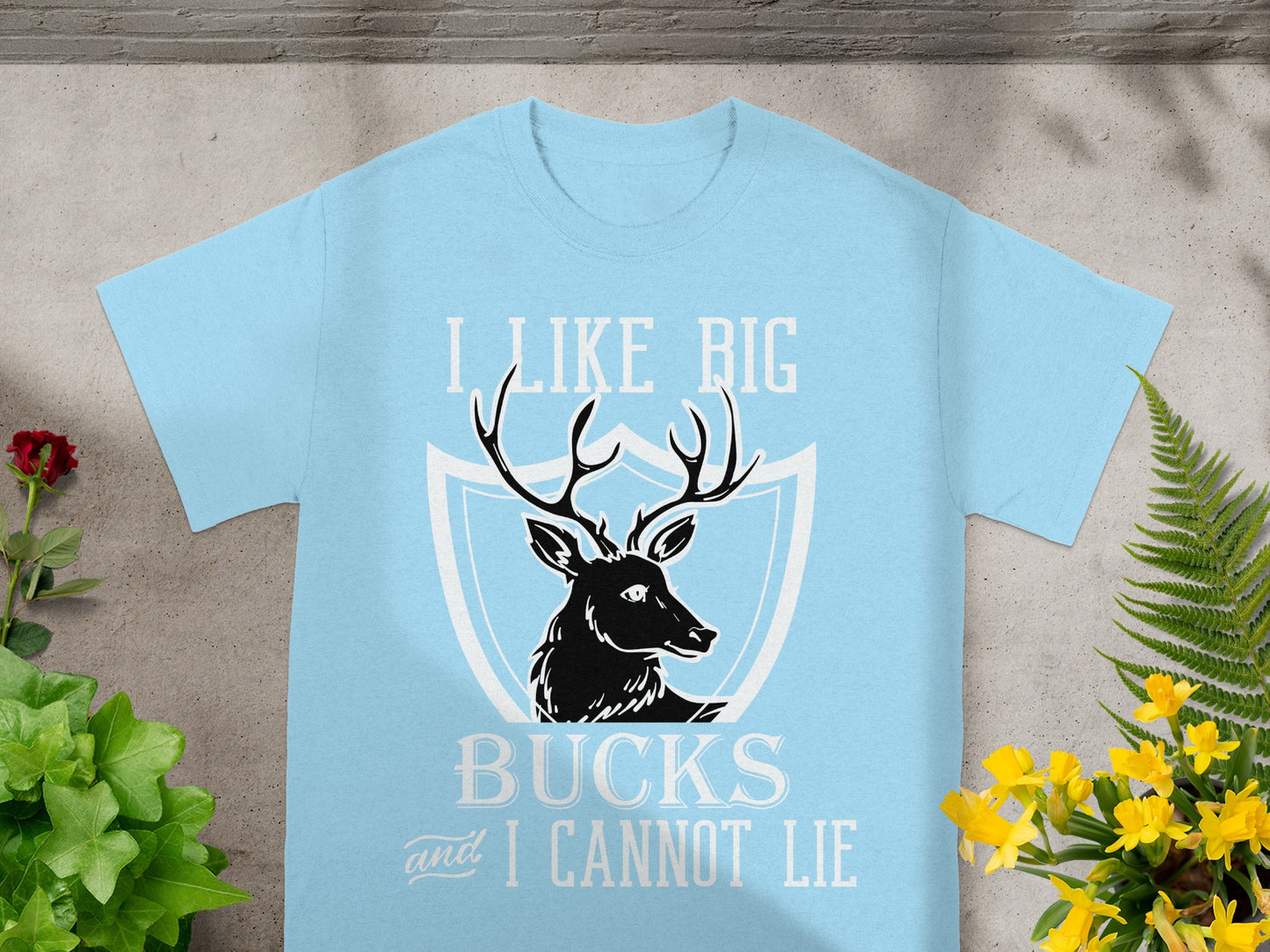 Light blue t-shirt with "I Like Big Bucks and I Cannot Lie" text and deer graphic.