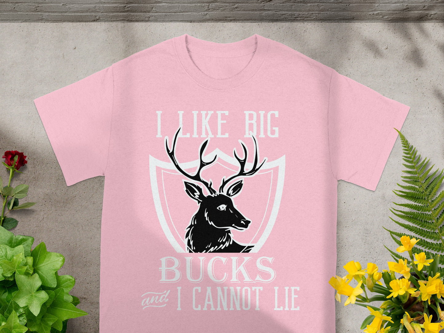 Pink t-shirt with "I Like Big Bucks and I Cannot Lie" and deer graphic.