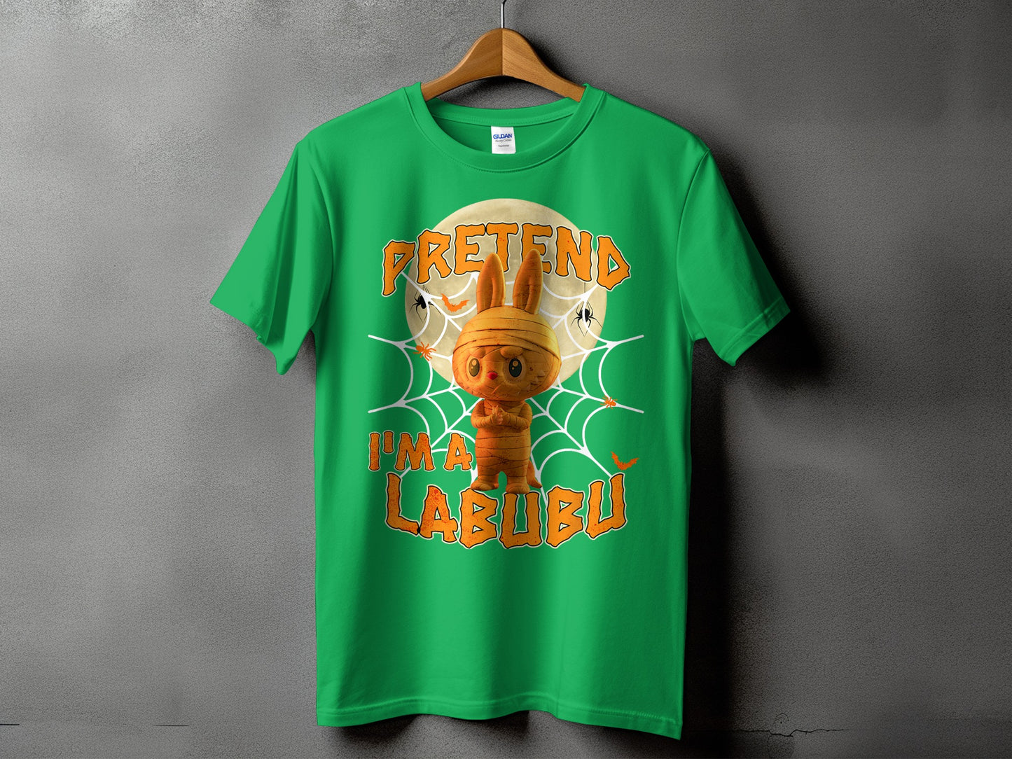 Green t-shirt with Halloween graphic "Pretend I'm a Labubu" and mummy bunny character.