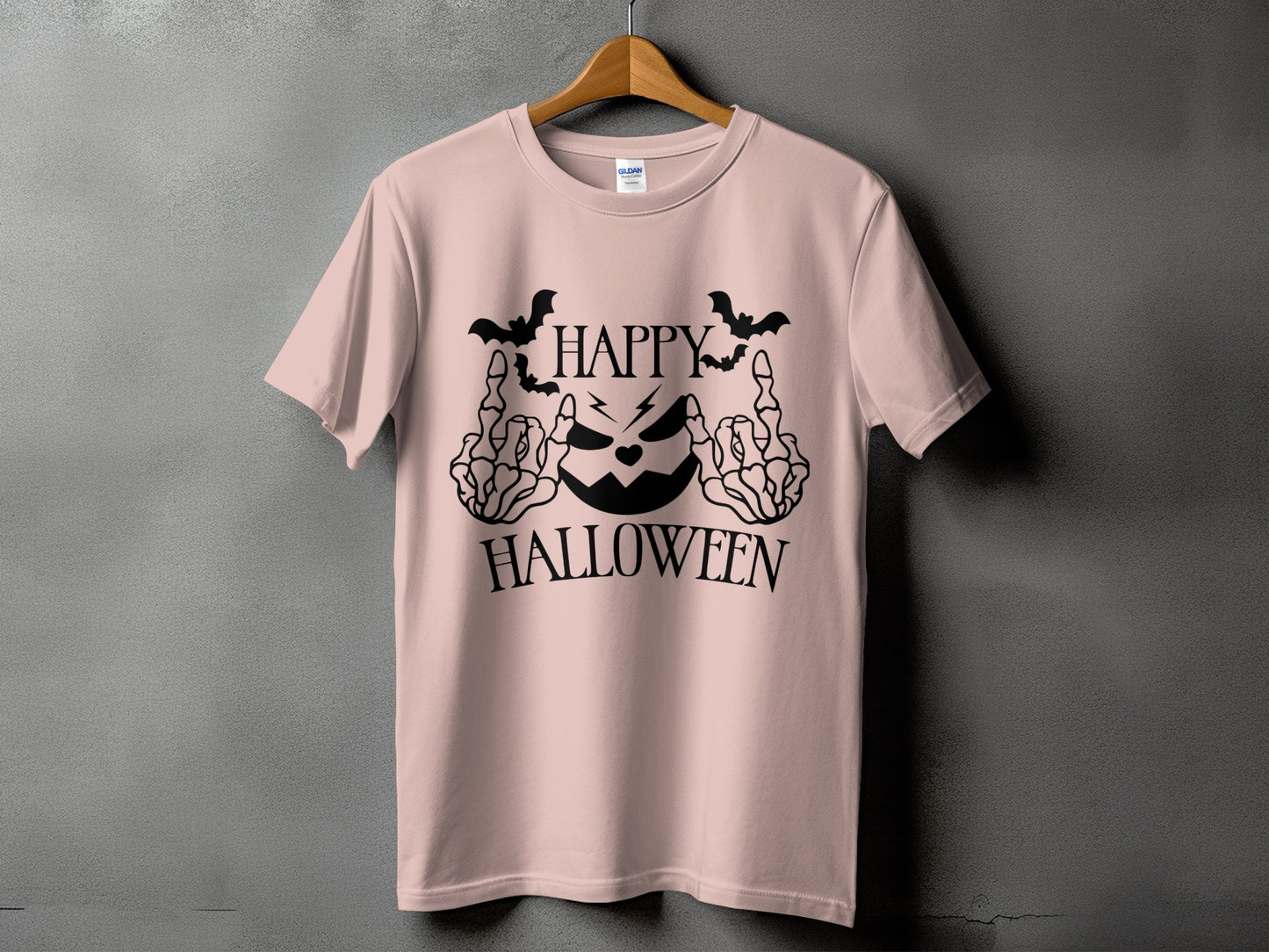 Pink t-shirt with black Halloween graphic featuring a jack-o'-lantern, bats, and skeleton hands.