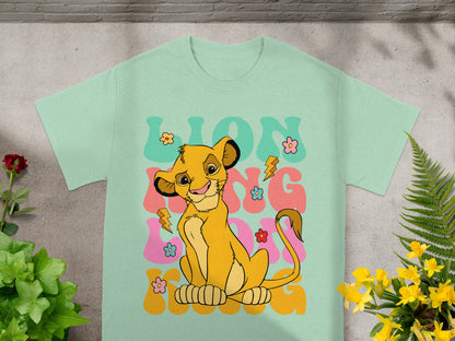 Mint t-shirt with Simba from The Lion King smiling and floral graphics.