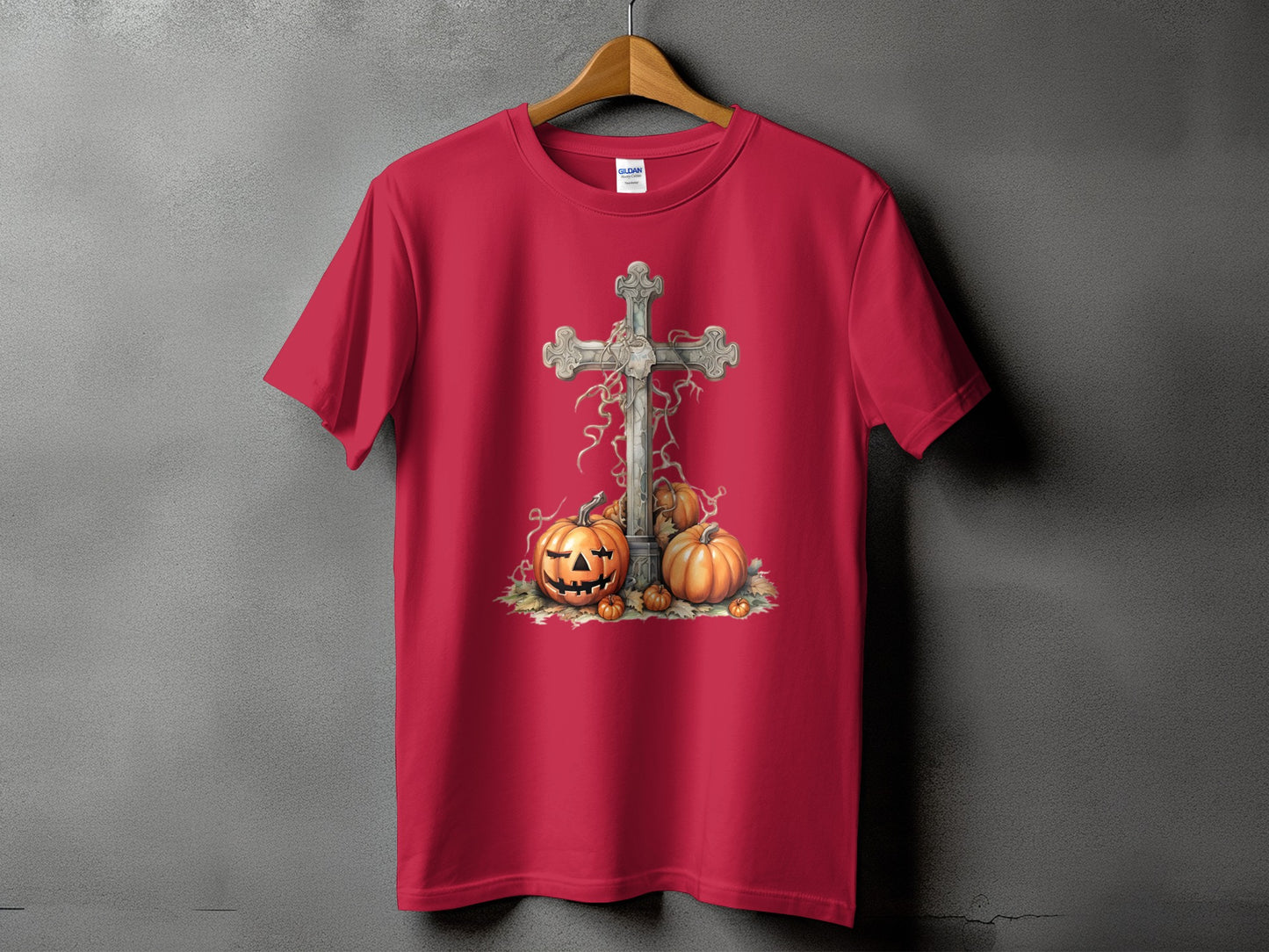 Red t-shirt with a Halloween-themed graphic of a cross surrounded by pumpkins.