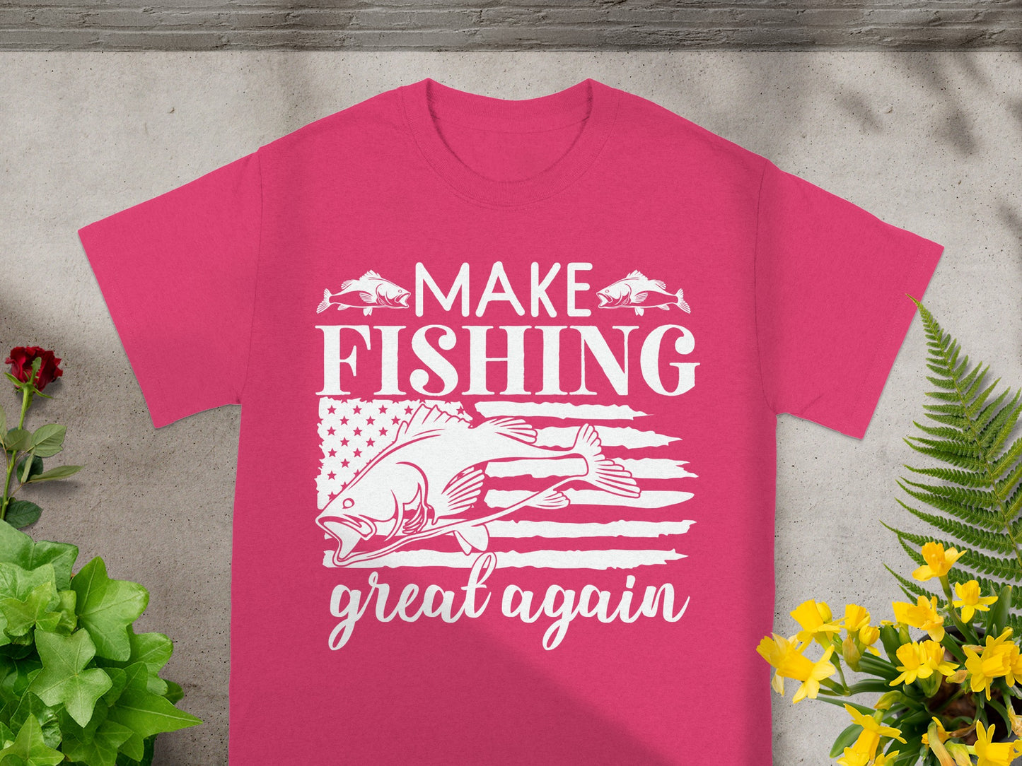 Pink t-shirt with white text and graphics of fish and American flag.