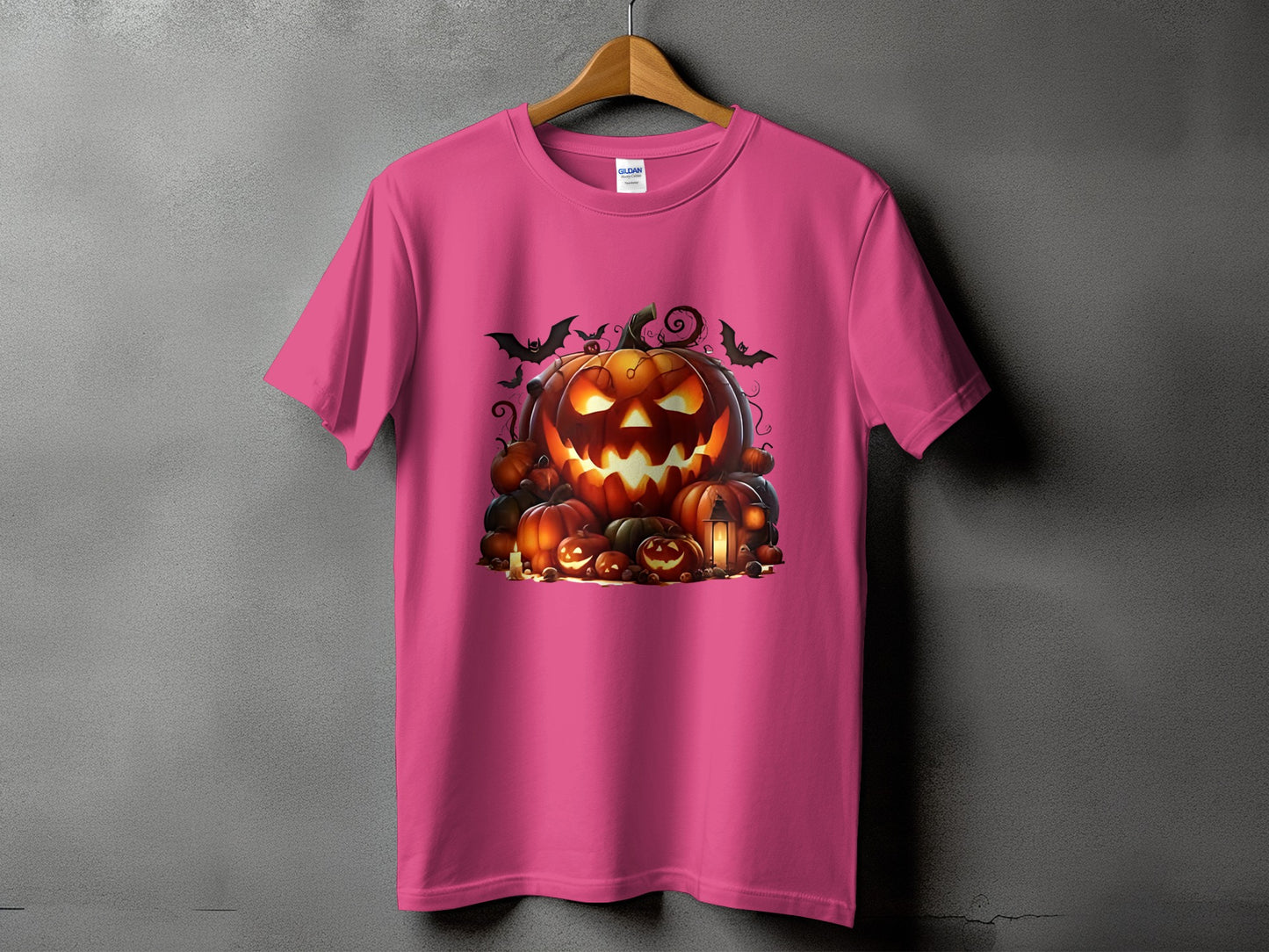 Pink t-shirt with a Halloween graphic featuring carved pumpkins and bats.