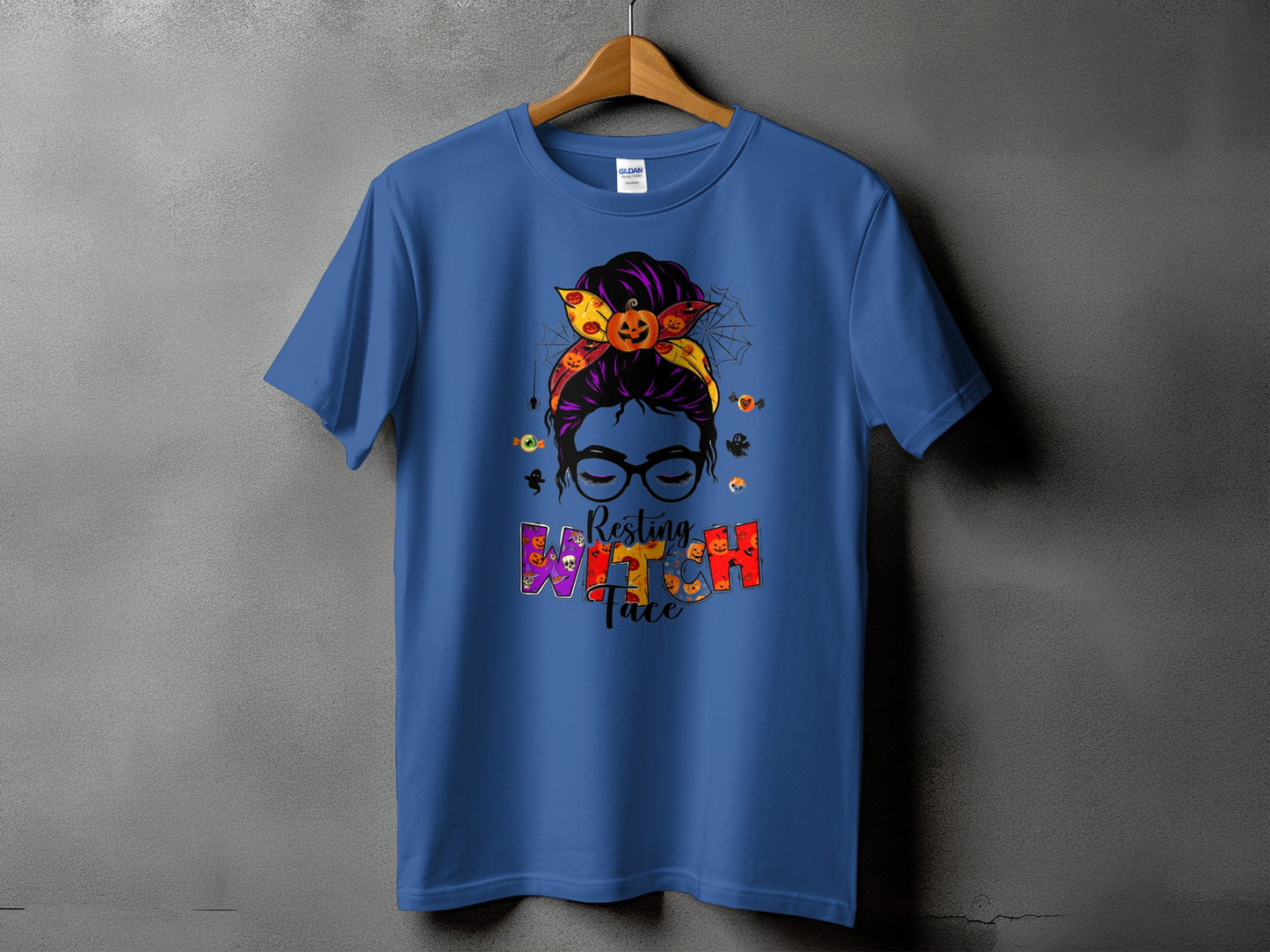 Blue t-shirt with "Resting Witch Face" Halloween graphic featuring a messy bun and pumpkins.