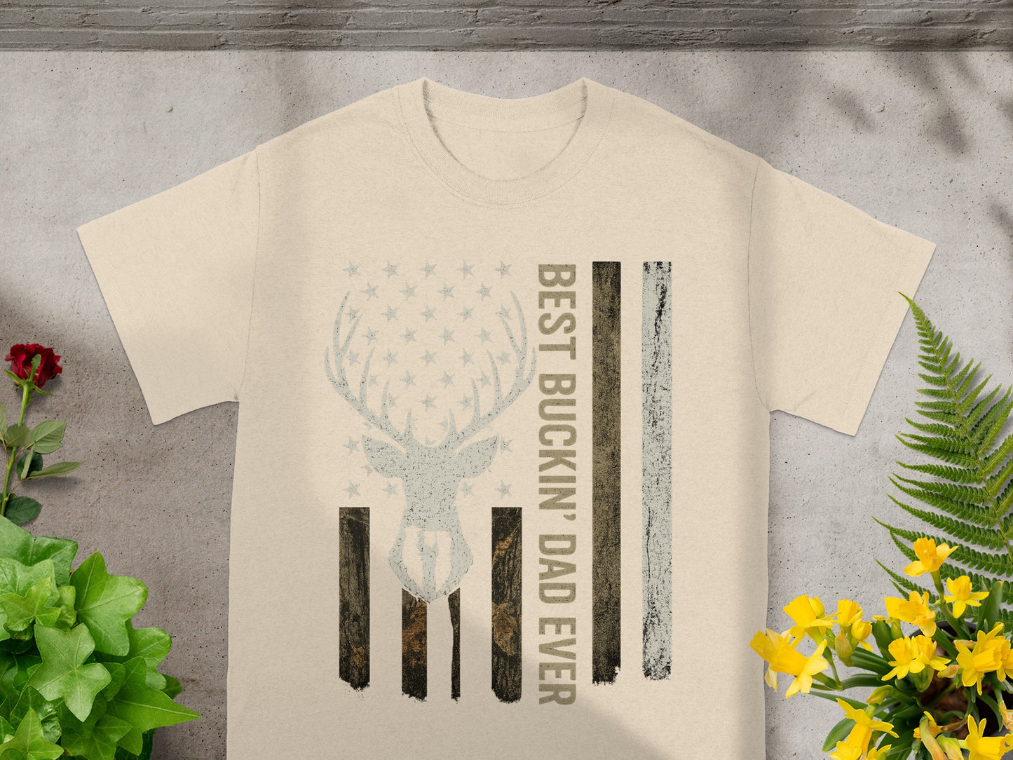 Lightweight t-shirt with a distressed flag design featuring a deer silhouette and "BEST BUCKiN' DAD EVER".