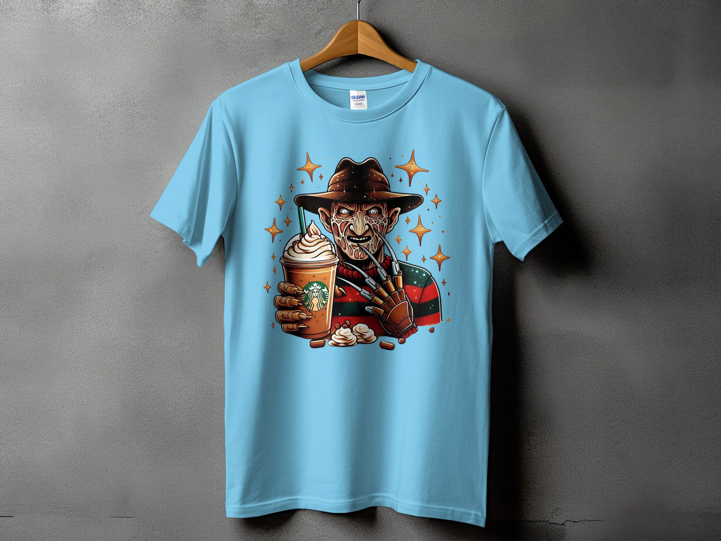 Light blue t-shirt featuring Freddy Krueger holding a Starbucks Frappuccino with star accents.