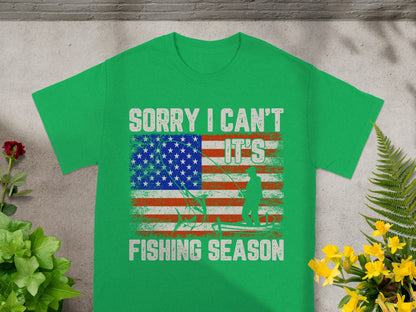 Green t-shirt with American flag, fisherman, and text "Sorry I can't it's fishing season".