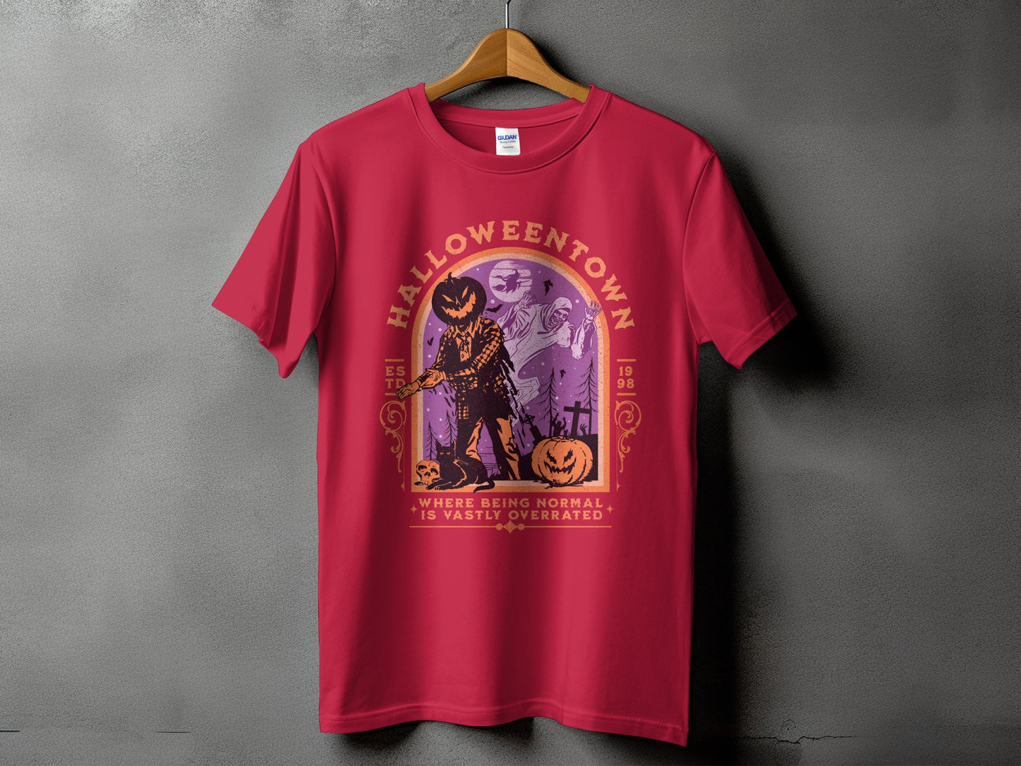 Red t-shirt with "Halloweentown" graphic featuring a scarecrow, ghosts, and pumpkins.