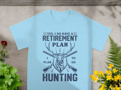 Light blue t-shirt with dark blue text and graphics of a deer, guns, and bullets.