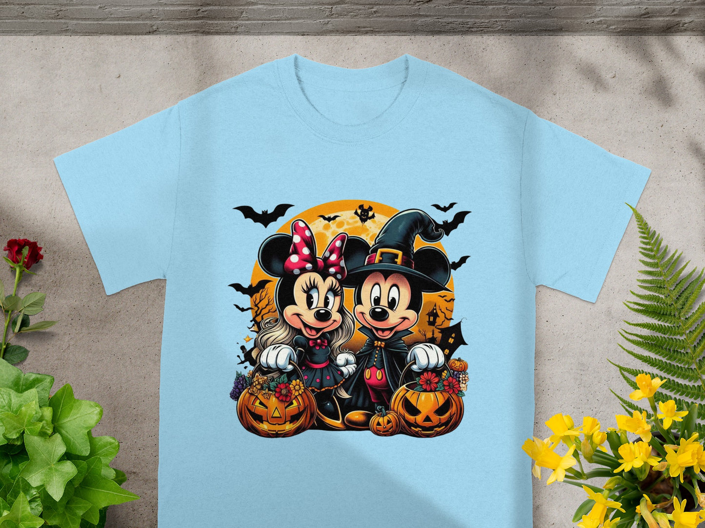 Minnie and Mickey Mouse in Halloween costumes with pumpkins and bats.