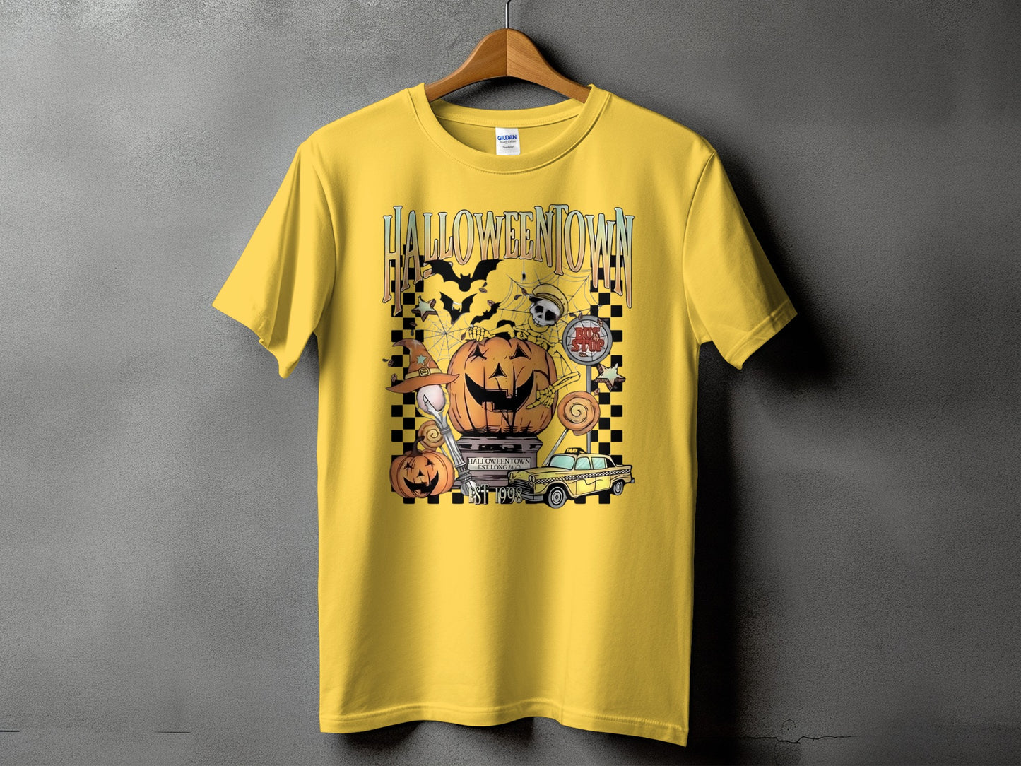 Yellow t-shirt with "HALLOWEENTOWN EST. 1998" graphic featuring pumpkins, bats, and a taxi.