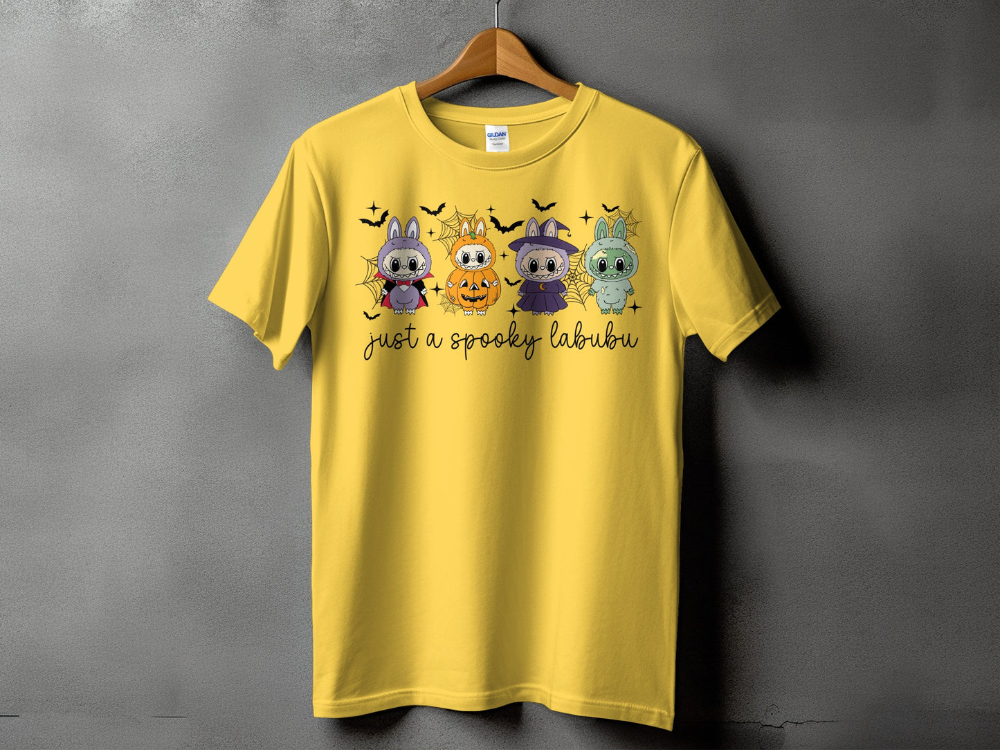 Yellow t-shirt with four Halloween-themed Labubu characters and "just a spooky labubu" text.