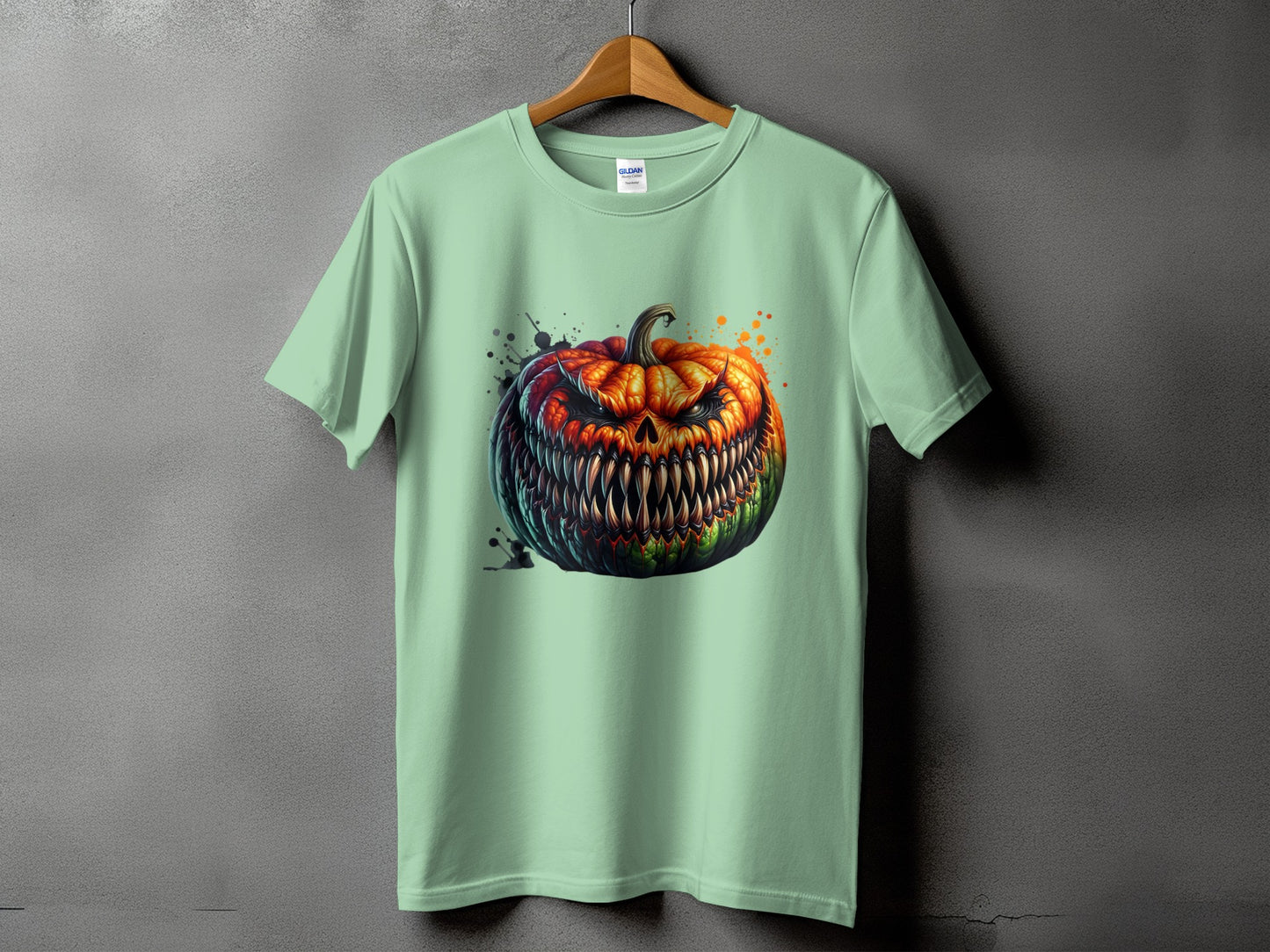 Light green t-shirt with a snarling jack-o'-lantern design and paint splatters.