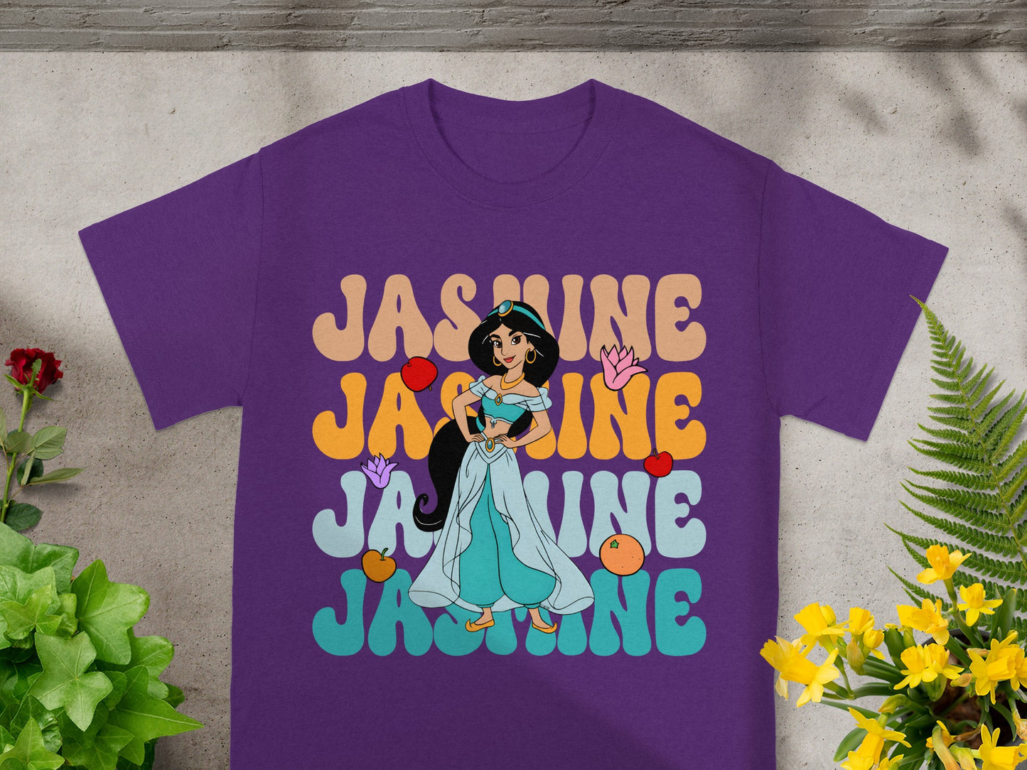 Purple t-shirt with "Jasmine" text and character illustration.
