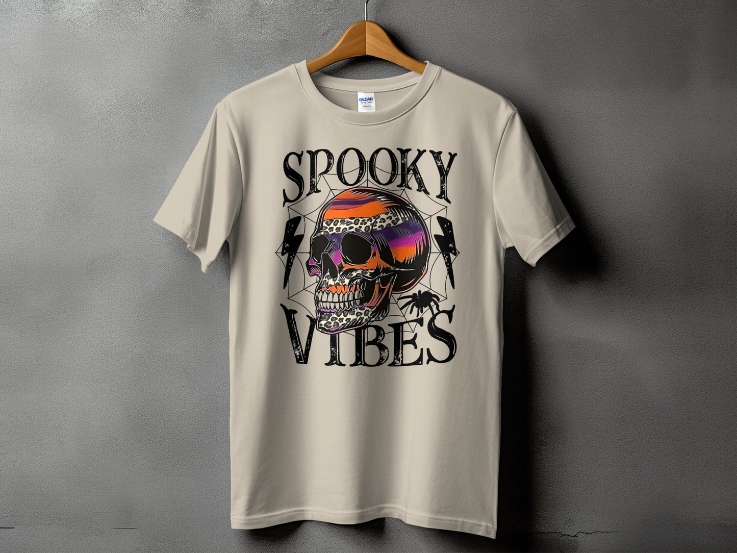 T-shirt with "Spooky Vibes" text and a colorful skull with spiderweb details.