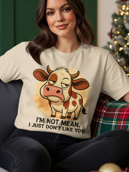 Cream t-shirt with grumpy cow graphic and text "I'm not mean, I just don't like you."