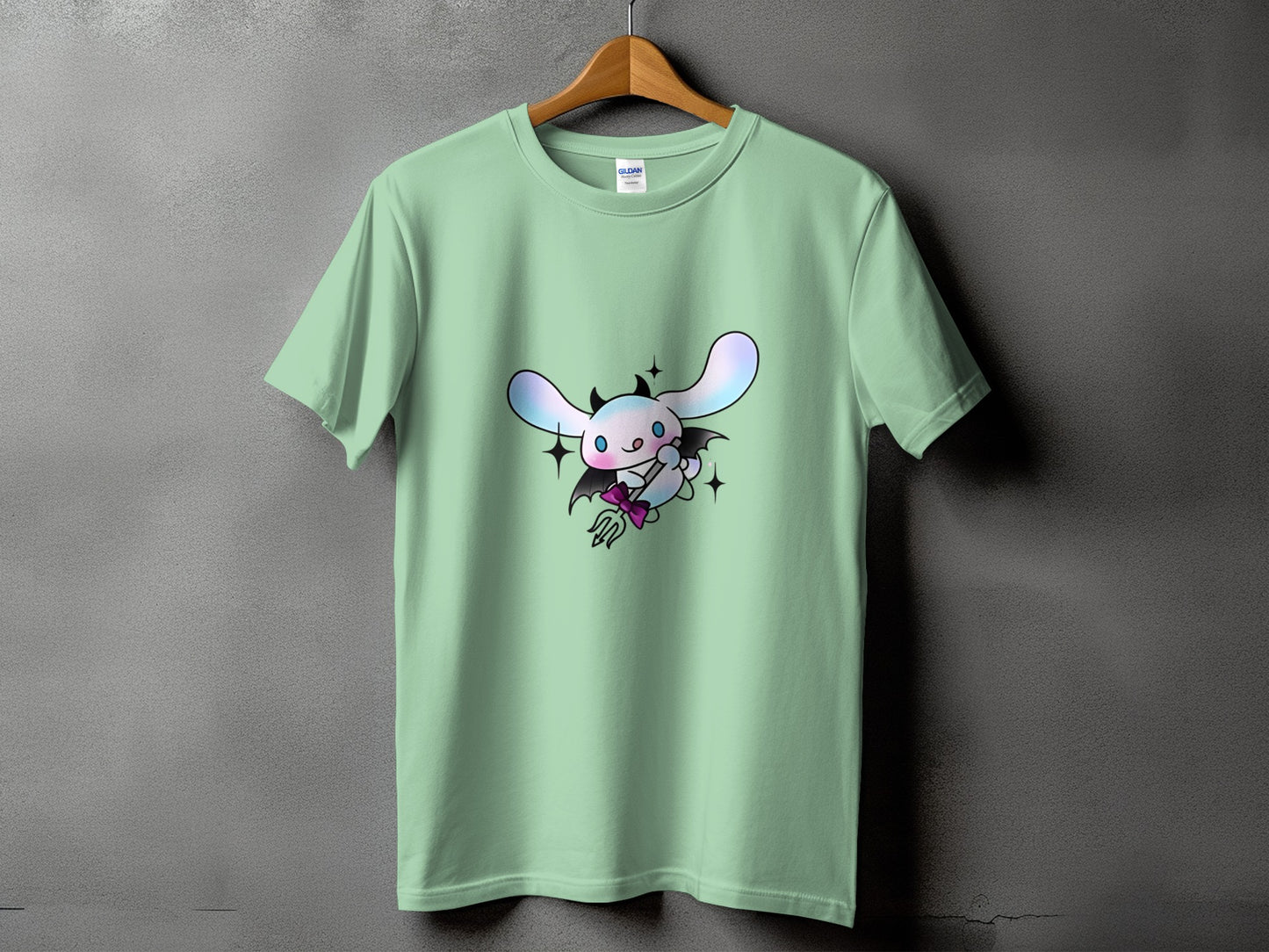 Mint green t-shirt with a cartoon devil bunny character holding a trident.