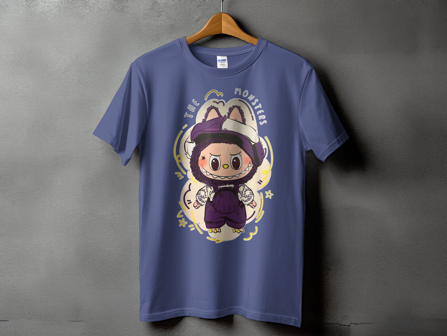 Purple t-shirt with graphic of a furry monster wearing overalls and a hat.