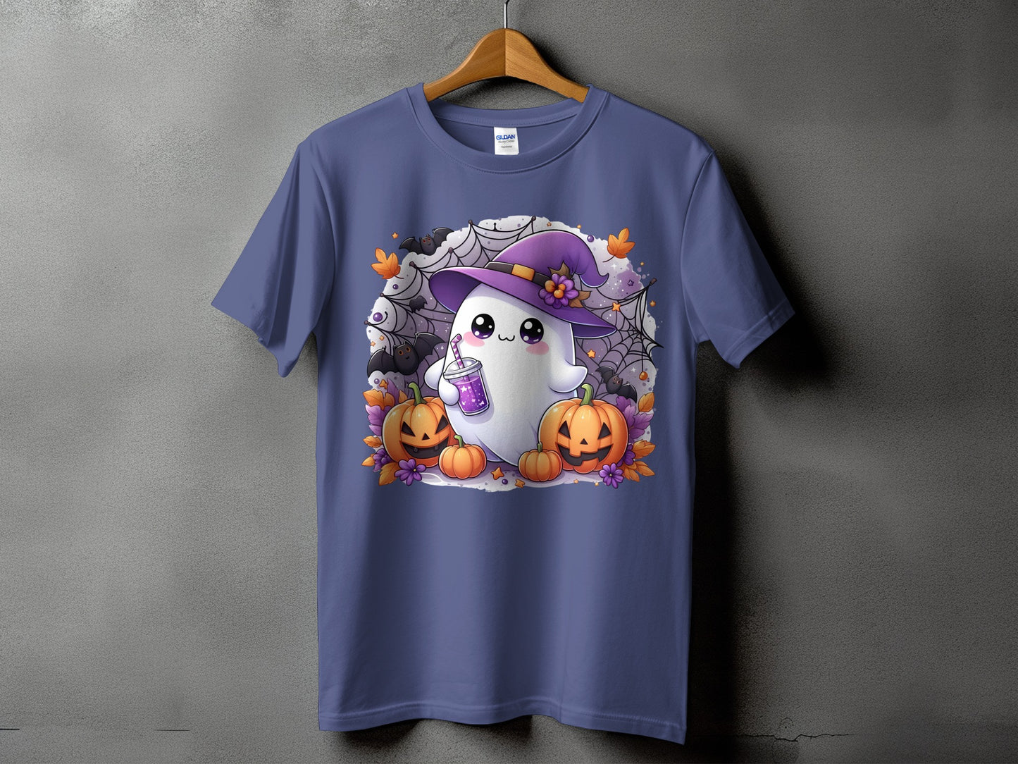 Cute ghost in witch hat with pumpkins, bats, and spiderwebs on a purple t-shirt.