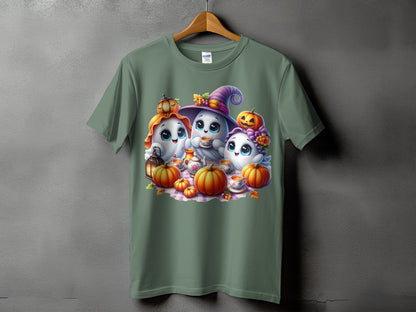 Three cartoon ghosts with pumpkins and tea set on a green t-shirt.