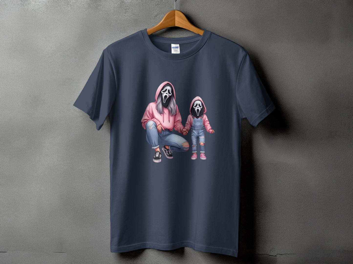 Illustration of two figures in Ghostface masks, a pink hoodie, and denim on a dark grey t-shirt.