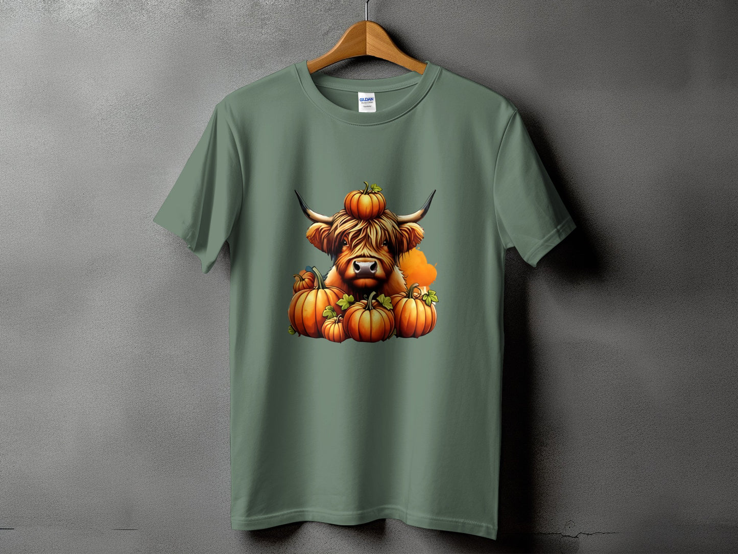 Green t-shirt featuring a Highland cow surrounded by pumpkins.